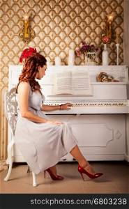 Beautiful redhead in white dress near piano