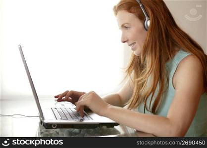 beautiful redhead secretary student laptop on talbe desk