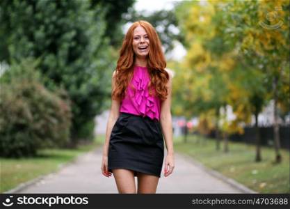 Beautiful redhead woman in a dress
