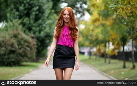 Beautiful redhead woman in a dress