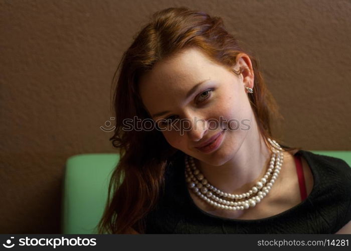 beautiful redheaded woman relaxing in a cafe