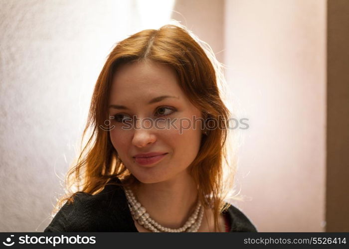 beautiful redheaded woman relaxing in a cafe