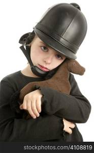 Beautiful riding cap little girl hug a toy horse isolated on white