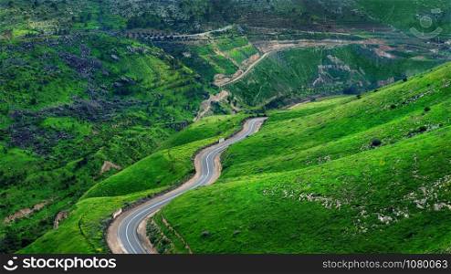 Beautiful road in Israel on the border with Jordan. Beautiful green hills and road. Golan Heights.