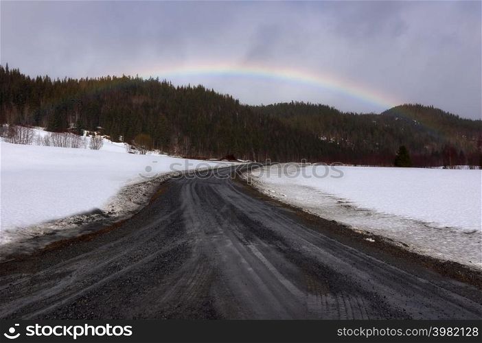 Beautiful road into mountain view with rainbow of scenic Lofoten Islands archipelago winter scenery, Beautiful mountain landscape in winter Norway, Scandinavia.. Winter in Norway.