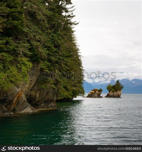 Beautiful rock buttes jut out of the ocean growing vegetation