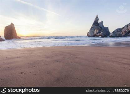 Beautiful rocky cliff beach at sunset, Sintra, Portugal