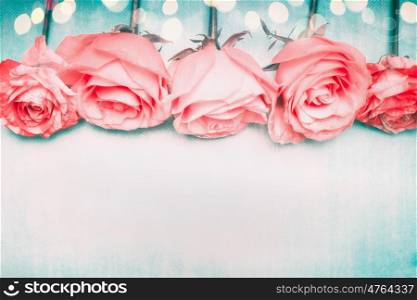 Beautiful romantic roses border on blue background with bokeh in pastel pale color