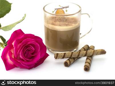 beautiful rose and cappuccino in the transparent mug