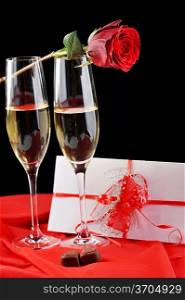 beautiful rose, champagne and letter with ribbon close up