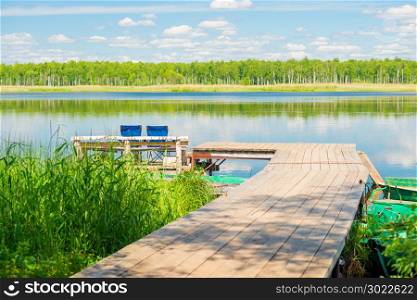 beautiful rural landscape - a wooden pier and a picturesque lake