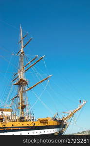 Beautiful sailing vessel with big masts on the mooring