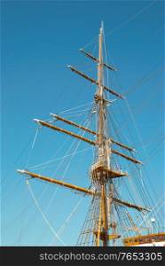 Beautiful sailing vessel with big masts on the mooring
