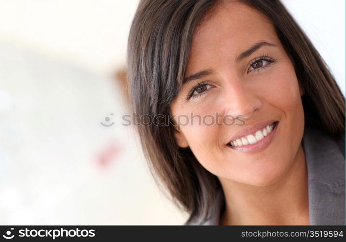 Beautiful saleswoman standing with group of business people