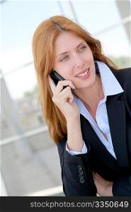 Beautiful saleswoman talking on mobile phone