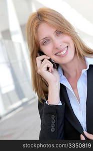 Beautiful saleswoman talking on mobile phone