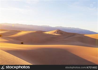 Beautiful sand dunes in desert at sunrise. Death Valley, Nevada, USA.