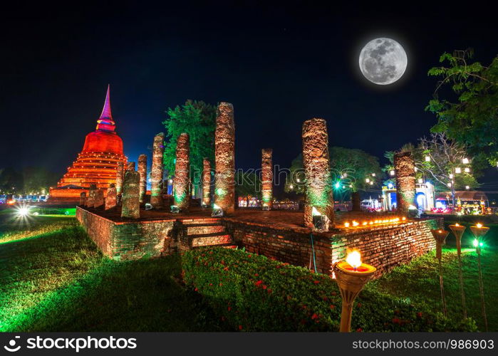 Beautiful scene of The light color Sukhothai Co Lamplighter Loy Kratong Festival at The Sukhothai Historical Park covers the ruins of Sukhothai, in what is now Northern Thailand.With full moon