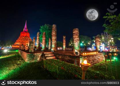 Beautiful scene of The light color Sukhothai Co Lamplighter Loy Kratong Festival at The Sukhothai Historical Park covers the ruins of Sukhothai, in what is now Northern Thailand.With full moon