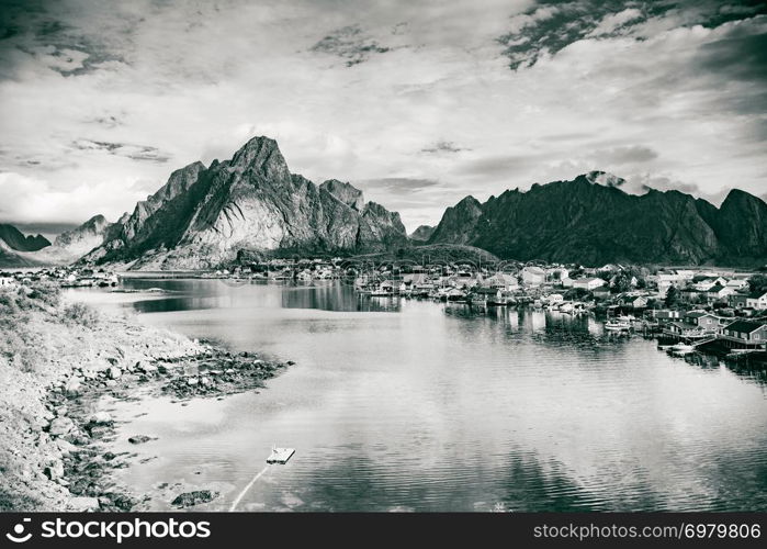 Beautiful scenery fjord landscape with Reine village, coast nature with sharp high mountain peaks, Lofoten islands North Norway. Travel destination. Black and white. Fjord and mountains landscape. Lofoten Norway