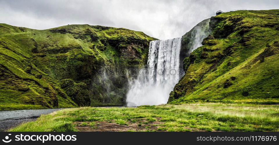 Beautiful scenery of the majestic Skogafoss Waterfall in countryside of Iceland in summer. Skogafoss waterfall is the top famous natural landmark and tourist destination place of Iceland and Europe.