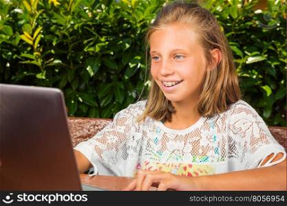 Beautiful schoolgirl,10 years old,have good news on the computer screen
