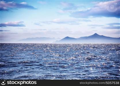 Beautiful sea landscape, amazing view on seascape in morning sunlight, silhouette of high mountains on the Greek islands, wonderful travel destination