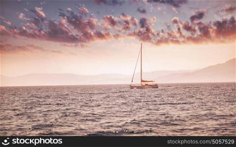 Beautiful sea landscape, sailboat sailing in the distance in mild pink sunset light, romantic vacation in the sea, beauty of summer nature