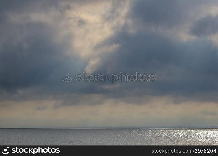Beautiful sea panorama with empty horizon line and cloudy sky. Morning sky with dramatic clouds and Baltic sea in Latvia. Landscape of Baltic sea with shimmering water.
