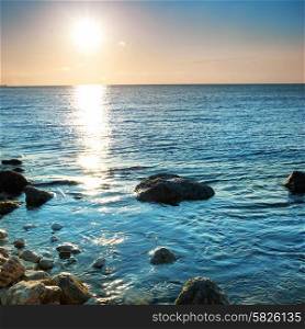 Beautiful sea sunset. Coast with stones and rocks