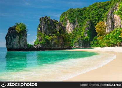 beautiful sea water on the beach and the mountains covered with greenery - view of the island of Hong, Thailand