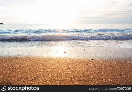 Beautiful sea wave and pebble at sunset. Amazing holiday and travel background.
