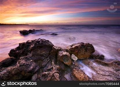 Beautiful seaascape. Sea and rock at the sunset. Nature composition.