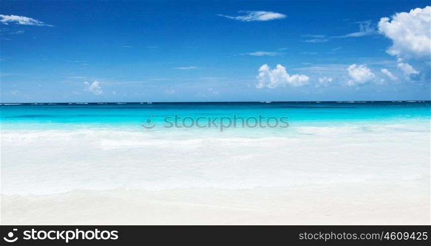 Beautiful seascape, clean turquoise sea, white sandy coastland, blue sky, exotic beach, luxury resort, summer vacation and holiday concept