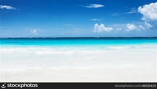 Beautiful seascape, clean turquoise sea, white sandy coastland, blue sky, exotic beach, luxury resort, summer vacation and holiday concept