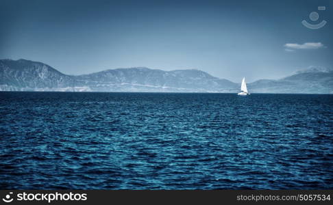 Beautiful seascape, dark blue sea on high mountains background, luxury yacht floating in the distance, summer vacation concept