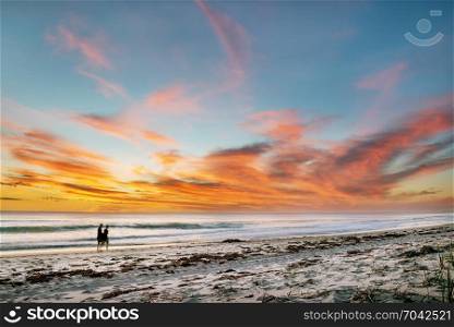 Beautiful seascape sunset over the sea with two romantic silhouette. Australia near Perth