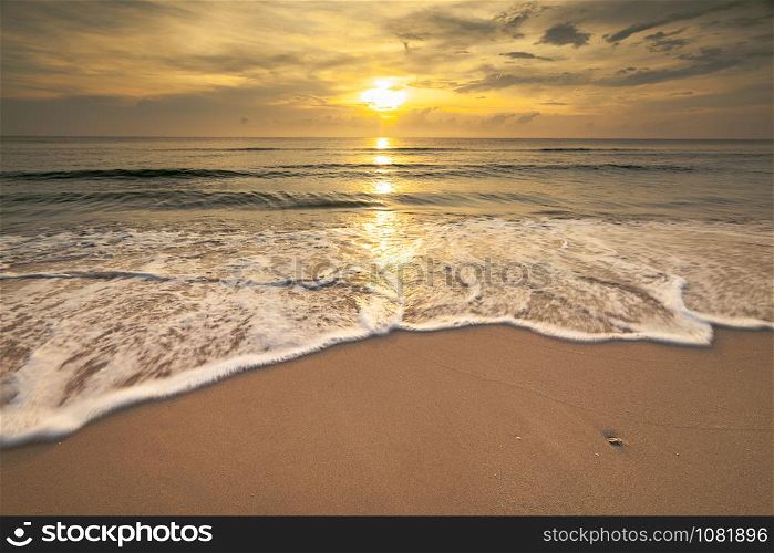 beautiful seascape the sun light and the sea wave bubble on the sand at morning time Chumphon beach sea Thailand long exposure shot