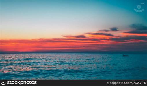 Beautiful seascape with amazing red sunset above it, abstract natural background, gorgeous evening view on the sea, beauty of nature