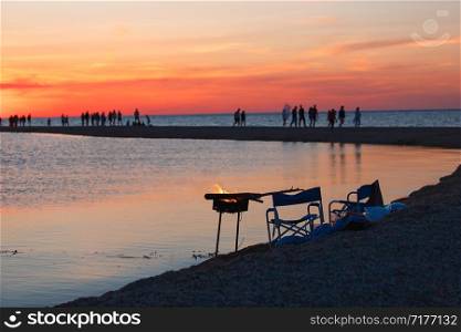 Beautiful seascape with people watching the sunset over the sea.. Beautiful seascape with people watching the sunset over the sea