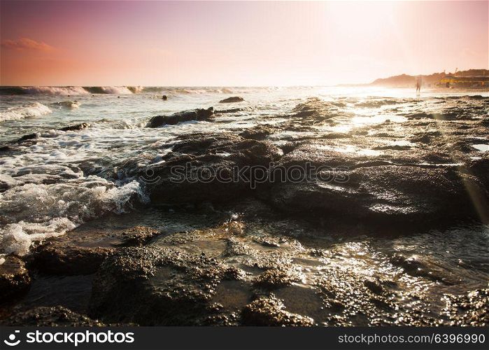 Beautiful seascape with silhouette of walkers on a sandy beach in summertime. The beautiful seascape