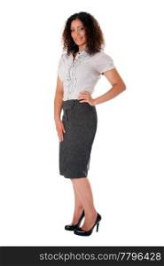 Beautiful self confident curly brunette corporate business woman standing with hand on hip and smiling wearing skirt blouse and black pumps, isolated.