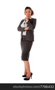 Beautiful self confident curly brunette corporate business woman standing with hand on chin and smiling wearing skirt blouse and black pumps, isolated.