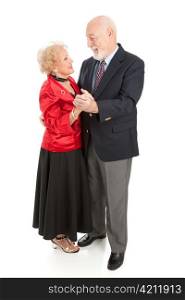 Beautiful senior couple dressed up and dancing together. Full body isolated on white.