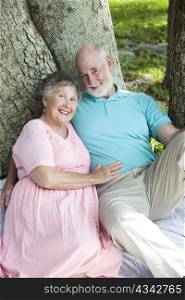 Beautiful senior couple enjoys a romantic moment in the park.