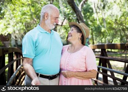 Beautiful senior couple flirting outdoors in the park.