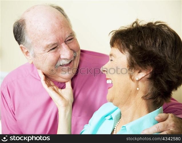 Beautiful senior couple in love, sharing a laugh together.