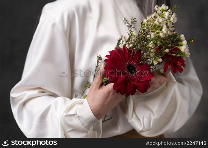 beautiful senior woman portrait with flowers close up
