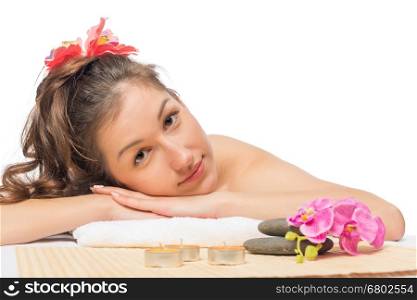 beautiful serene brunette on massage table at spa cabinet