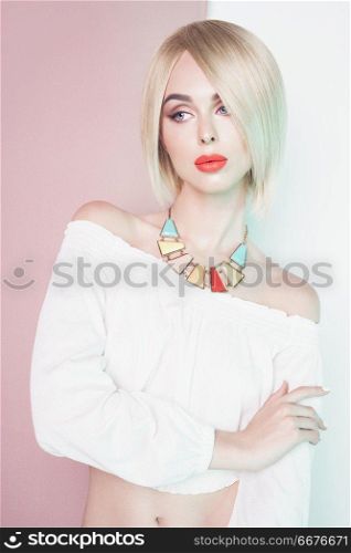 Beautiful sexy blonde with professional classic make-up pose in photography studio. Sensual stylish woman in erotic white dress. Blue-eyed lady with perfect lips and red lipstick.